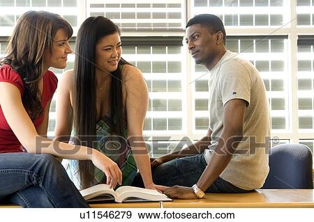 Group of 3 students seated casually in classroom, in front of solar panelled windows, Winnipeg, Canada View Large Photo Image Stock Photo - Group of 3 students seated casually in classroom, in front of solar panelled windows, Winnipeg, Canada. Fotosearch