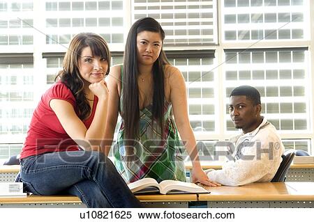 Group of 3 students seated casually in classroom, in front of solar panelled windows, Winnipeg, Canada View Large Photo Image Stock Photography - Group of 3 students seated casually in classroom, in front of solar panelled windows, Winnipeg, Canada. Fotosearch