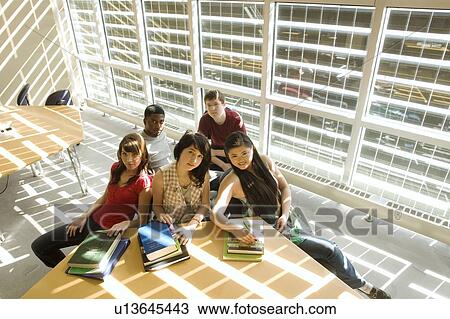 High angle portrait of students seated around table in front of solar panelled windows, Winnipeg, Canada View Large Photo Image Stock Image - High angle portrait of students seated around table in front of solar panelled windows, Winnipeg, Canada. Fotosearch