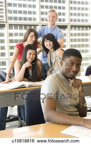 Male student foreground, group of students in background, in front of solar panelled windows, Winnipeg, Canada. View Large Photo Image Stock Photograph - Male student foreground, group of students in background, in front of solar panelled windows, Winnipeg, Canada.. Fotosearch