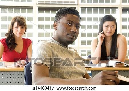 Male student foreground, two female students background, in front of solar panelled windows, Winnipeg, Canada. View Large Photo Image Stock Photo - Male student foreground, two female students background, in front of solar panelled windows, Winnipeg, Canada.. Fotosearch