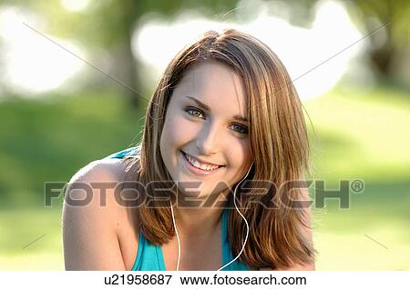 Stock Photo - Teenage girl in park w/ipod, Regina, Saskatchewan. Fotosearch