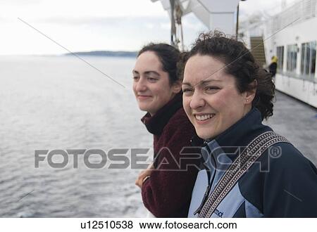 Stock Photo - Two sisters enjoy the view from a BC Ferry. Fotosearch