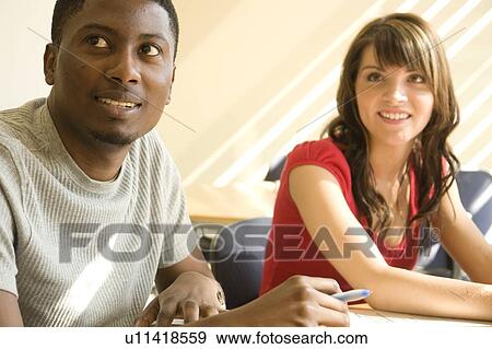 Two students seated at table, Winnipeg, Canada View Large Photo Image Stock Photo - Two students seated at table, Winnipeg, Canada. Fotosearch