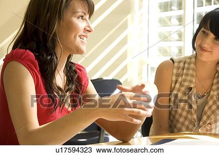 Two students seated, talking, Winnipeg, Canada View Large Photo Image Stock Image - Two students seated, talking, Winnipeg, Canada. Fotosearch