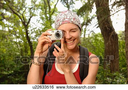 Woman in woods with camera, Regina, Saskatchewan View Large Photo Image Stock Photograph - Woman in woods with camera, Regina, Saskatchewan. Fotosearch