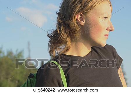 Stock Image - Woman with hemp satchel at lakeside, Clear Lake, Riding Mountain National Park, Manitoba, Canada. Fotosearch