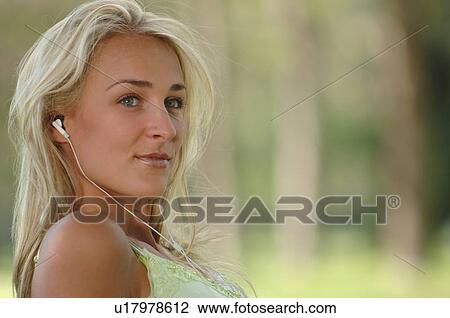 Young blonde female in park with earphones, Regina, Saskatchewan View Large Photo Image Stock Image - Young blonde female in park with earphones, Regina, Saskatchewan. Fotosearch