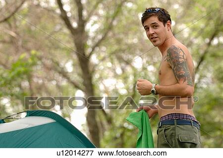 Young man w/tattoo in front of tent, Regina, Saskatchewan View Large Photo Image Stock Photo - Young man w/tattoo in front of tent, Regina, Saskatchewan. Fotosearch