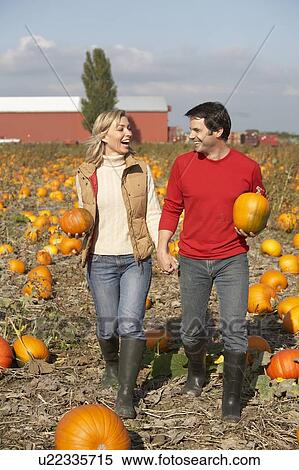 Couple in organic pumpkin patch, Ladner, British Columbia, Canada View Large Photo Image Stock Photography - Couple in organic pumpkin patch, Ladner, British Columbia, Canada. Fotosearch