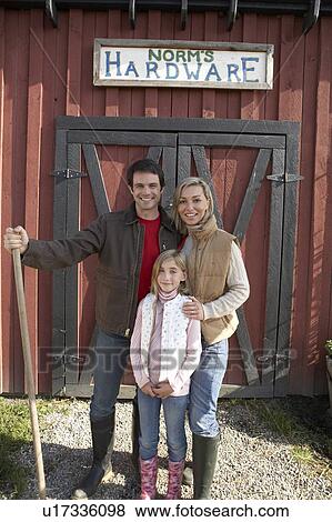 Stock Photo - Family stand beside barn, at organic farm, Ladner, British Columbia, Canada. Fotosearch
