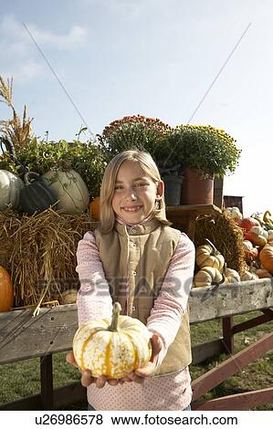 Girl holding organic squash, British Columbia, Ladner, Canada View Large Photo Image Stock Photo - Girl holding organic squash, British Columbia, Ladner, Canada. Fotosearch