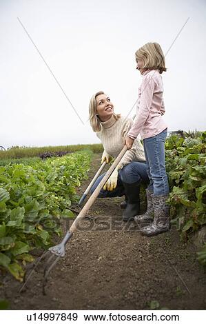 Mother and daughter gardening together in organic garden, Ladner, British Columbia, Canada View Large Photo Image Stock Photo - Mother and daughter gardening together in organic garden, Ladner, British Columbia, Canada. Fotosearch