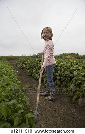 Young girl, 9 yrs, gardening in organic garden, Ladner, British Columbia, Canada View Large Photo Image Stock Photo - Young girl, 9 yrs, gardening in organic garden, Ladner, British Columbia, Canada. Fotosearch