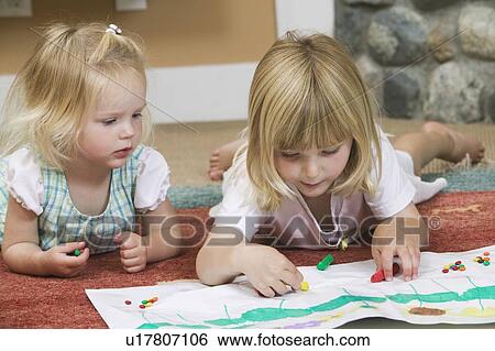 Stock Photograph - 3 and 5 year old sister doing artwork, B. C.. Fotosearch