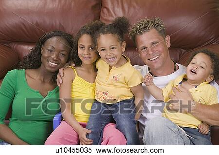 Stock Photography - AA mom, Caucasian dad, Mulatto Children, Boy 1. 5 years, girl 3 years, girl 6 years.. Fotosearch