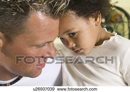 Stock Photo - Caucasian father and Mulatto girl 3 years old.. Fotosearch