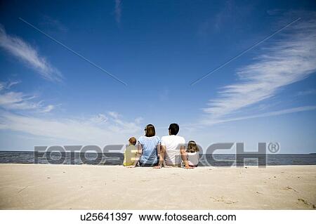 Family of four seated on beach with backs to camera, Grand Beach Provincial Park, Manitoba, Canada View Large Photo Image Stock Photo - Family of four seated on beach with backs to camera, Grand Beach Provincial Park, Manitoba, Canada. Fotosearch