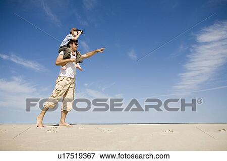 Man carries boy (7) on his shoulders, Grand Beach Provincial Park, Manitoba, Canada View Large Photo Image Stock Photo - Man carries boy (7) on his shoulders, Grand Beach Provincial Park, Manitoba, Canada. Fotosearch
