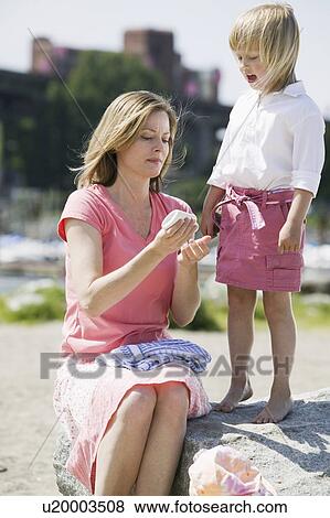 Mom applying sunscreen, Caucasian Mom and 4 year old Daughter. Sunset Beach, Vancouver, BC View Large Photo Image Stock Photo - Mom applying sunscreen, Caucasian Mom and 4 year old Daughter. Sunset Beach, Vancouver, BC. Fotosearch