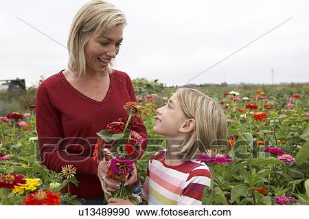 Mother and daughter in a field of organic flowers, Ladner, British Columbia, Canada View Large Photo Image Stock Image - Mother and daughter in a field of organic flowers, Ladner, British Columbia, Canada. Fotosearch