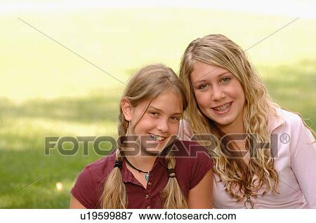 Portrait of young girls on grass, Regina, Saskatchewan View Large Photo Image Stock Photo - Portrait of young girls on grass, Regina, Saskatchewan. Fotosearch