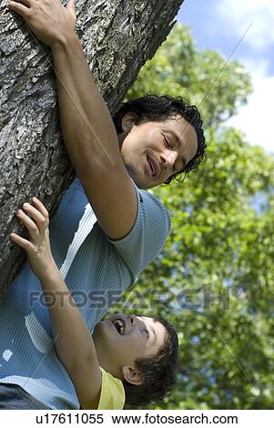 Six year old boy and father hugging tree, Assiniboine Park, Winnipeg, Canada View Large Photo Image Stock Photography - Six year old boy and father hugging tree, Assiniboine Park, Winnipeg, Canada. Fotosearch