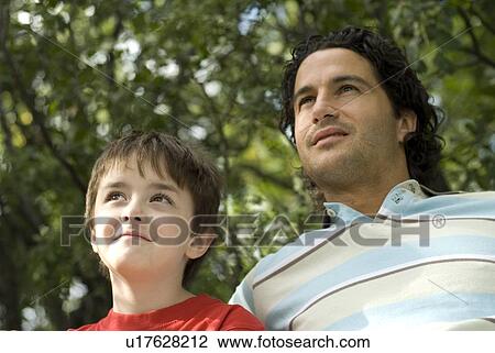 Six year old boy and father looking upward, Winnipeg, Canada View Large Photo Image Stock Image - Six year old boy and father looking upward, Winnipeg, Canada. Fotosearch