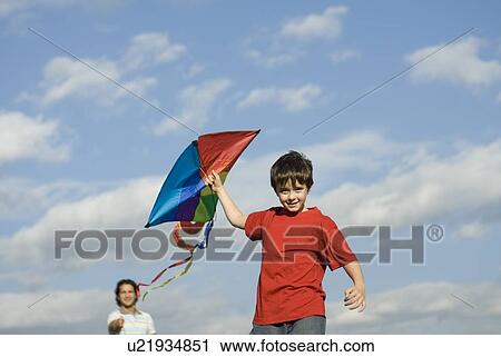 Six year old boy and father try to fly a kite, Assiniboine Park, Winnipeg, Canada View Large Photo Image Stock Image - Six year old boy and father try to fly a kite, Assiniboine Park, Winnipeg, Canada. Fotosearch