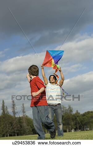 Six year old boy and father try to fly a kite, Assiniboine Park, Winnipeg, Canada View Large Photo Image Stock Photograph - Six year old boy and father try to fly a kite, Assiniboine Park, Winnipeg, Canada. Fotosearch