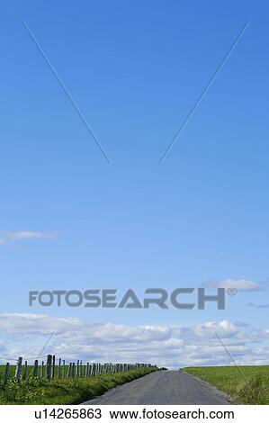 Stock Image - Country road with fence.. Fotosearch