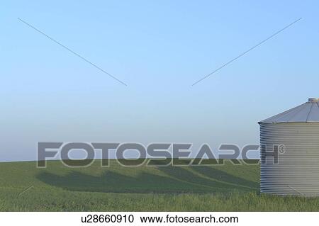 Stock Image - Metal Grainery and shadow; Canada, Manitoba, Erickson. Fotosearch