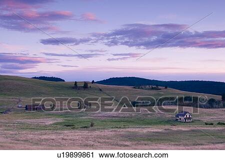 Stock Image - Rural farmland and an abandoned farmhouse; Canada, British Columbia, Bridesville, Boundary Country. Fotosearch