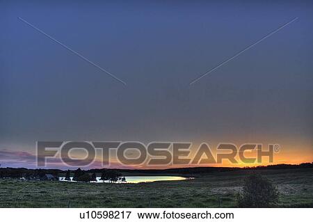 Sunset over farmland and slough; Canada, Manitoba, Erickson View Large Photo Image Stock Photo - Sunset over farmland and slough; Canada, Manitoba, Erickson. Fotosearch