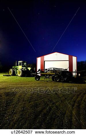 Tractor in farmyard at night, Outlook, Saskatchewan, Canada View Large Photo Image Stock Photo - Tractor in farmyard at night, Outlook, Saskatchewan, Canada. Fotosearch