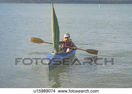 Picture - 45 year old woman boating in Clear Lake,; Canada, Manitoba, Riding Mountain National Park. Fotosearch