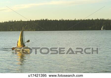Stock Photography - 45 year old woman Kayaking on Clear Lake; Canada, Manitoba, Riding Mountain National Park. Fotosearch
