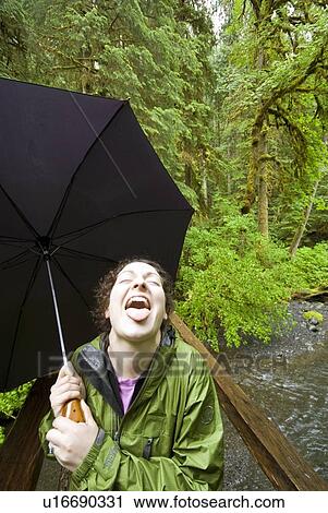 Stock Image - A woman enjoying the rainforest near Marymere Falls in Olympic National Park. Fotosearch