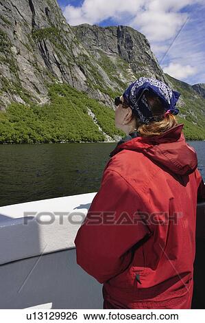Stock Photograph - View of woman on boat tour, Western Brook Pond, Gros Morne NP, Newfoundland, Canada. Fotosearch