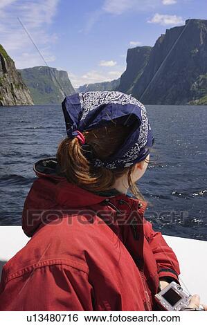 Stock Photograph - View of woman on boat tour, Western Brook Pond, Gros Morne NP, Newfoundland, Canada. Fotosearch
