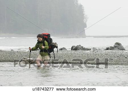 Woman (20-25) crossing a fast-flowing creek with a large backpack on, West Coast Trail, Pacific Rim National Park Reserve, BC View Large Photo Image Stock Photo - Woman (20-25) crossing a fast-flowing creek with a large backpack on, West Coast Trail, Pacific Rim National Park Reserve, BC. Fotosearch