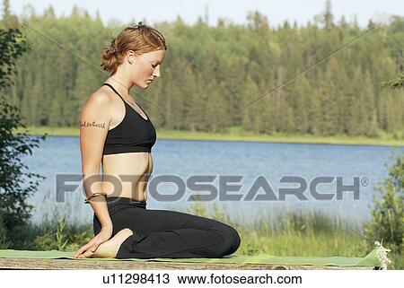 Woman seated on yoga mat, Grayling Lake, Riding Mountain National Park, Manitoba, Canada View Large Photo Image Stock Image - Woman seated on yoga mat, Grayling Lake, Riding Mountain National Park, Manitoba, Canada. Fotosearch