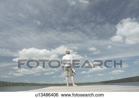 Woman standing on dock, Clear Lake; Canada, Manitoba, Riding Mountain National Park View Large Photo Image Stock Photograph - Woman standing on dock, Clear Lake; Canada, Manitoba, Riding Mountain National Park. Fotosearch