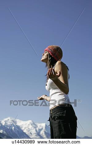 Stock Photo - Young girl in zen position in front of Mont Blanc, Col de Balme Chamonix, France. Fotosearch