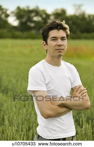 Young man in barley field View Large Photo Image Stock Image - Young man in barley field. Fotosearch