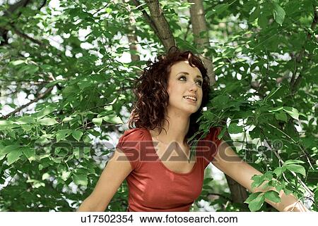 Young woman in front of green leaves, Munson Park, Winnipeg, Canada View Large Photo Image Picture - Young woman in front of green leaves, Munson Park, Winnipeg, Canada. Fotosearch