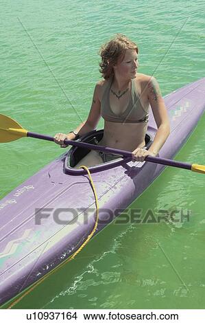 Young woman seated in kayak on Lake Katherine, Riding Mountain National Park, Manitoba, Canada View Large Photo Image Picture - Young woman seated in kayak on Lake Katherine, Riding Mountain National Park, Manitoba, Canada. Fotosearch