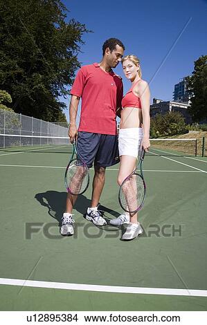 Couple on tennis court; Canada, British Columbia, Vancouver View Large Photo Image Picture - Couple on tennis court; Canada, British Columbia, Vancouver. Fotosearch