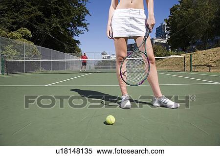 Stock Photography - Couple on tennis court; Canada, British Columbia, Vancouver. Fotosearch