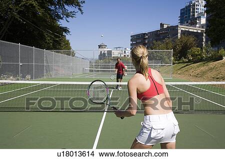 Picture - Couple playing tennis; Canada, British Columbia, Vancouver. Fotosearch